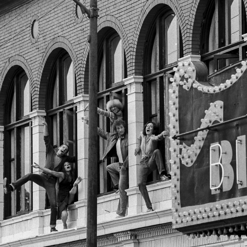 Chicago Moving Company at Chicago Dance Center on Lincoln Five dancers from the Chicago Moving Company pose out of a window on the outside of the Biograph Theater.