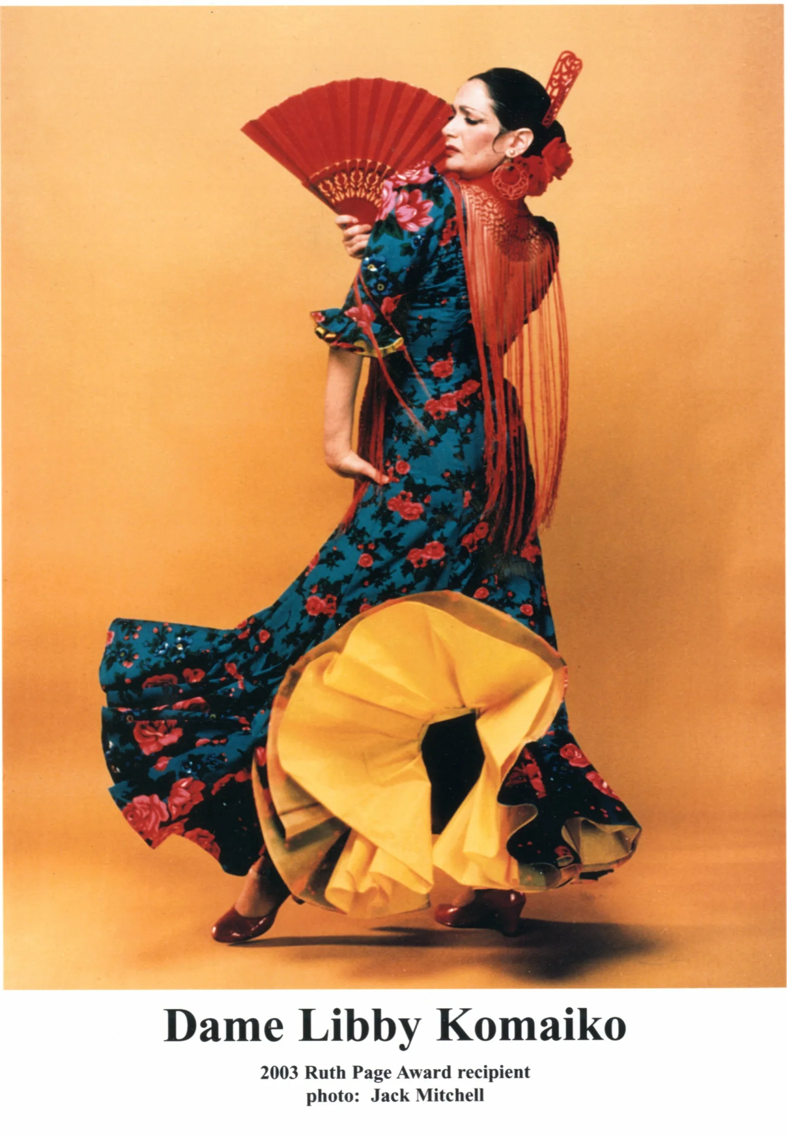 DMS Barzel Research 001 Dame Libby Komaiko poses in brightly colored flamenco dress.