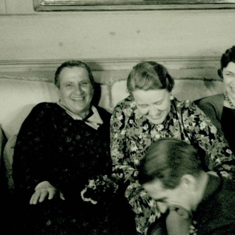 Gertrude Stein and Fanny Butcher Four women sit on a couch laughing.