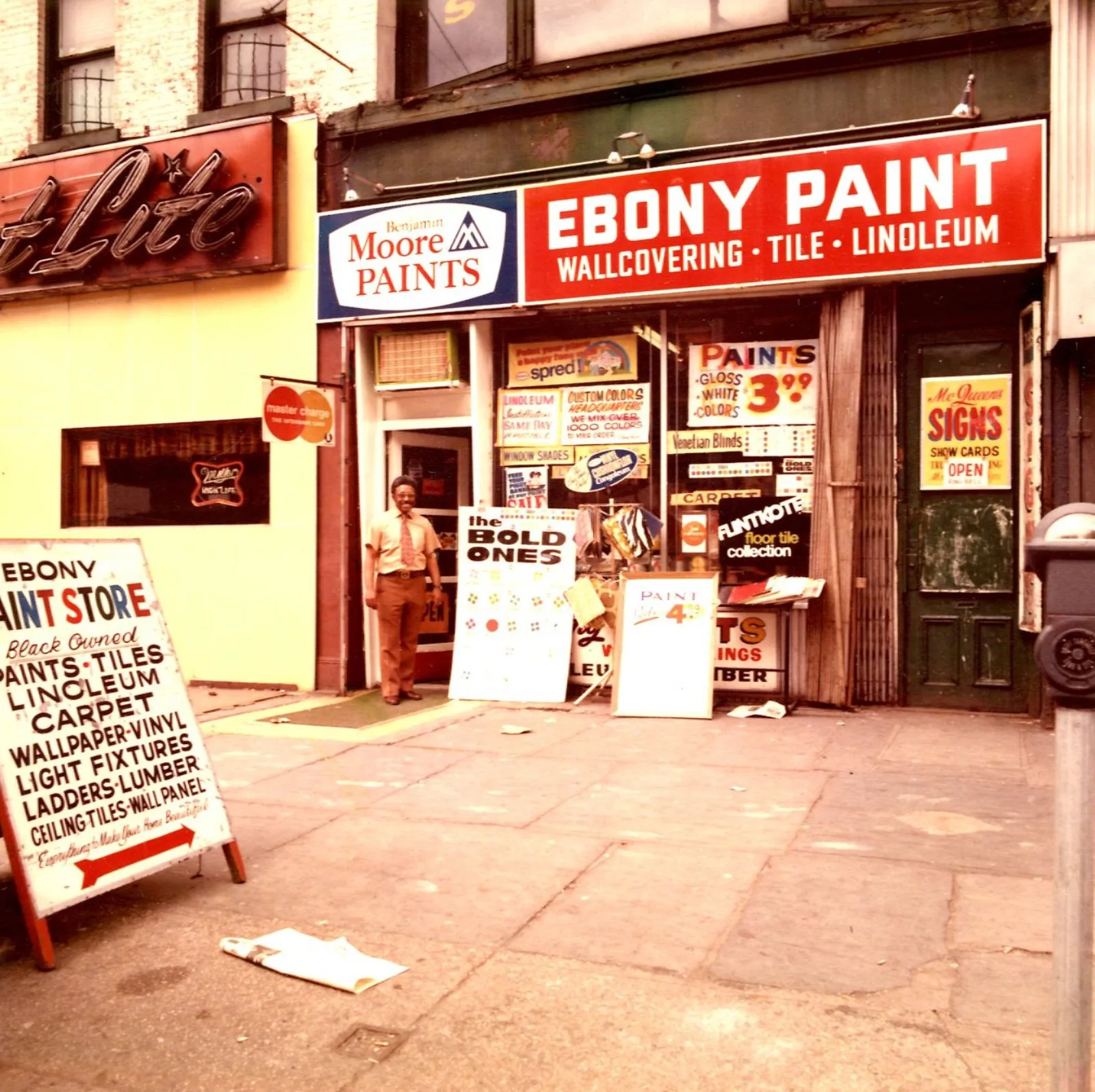 MMS Prescott 039 Ebony Paints exterior Above the Ebony Paint storefront is a red sign with white letters: Ebony Paint: Wallcovering, Tile, Linoleum