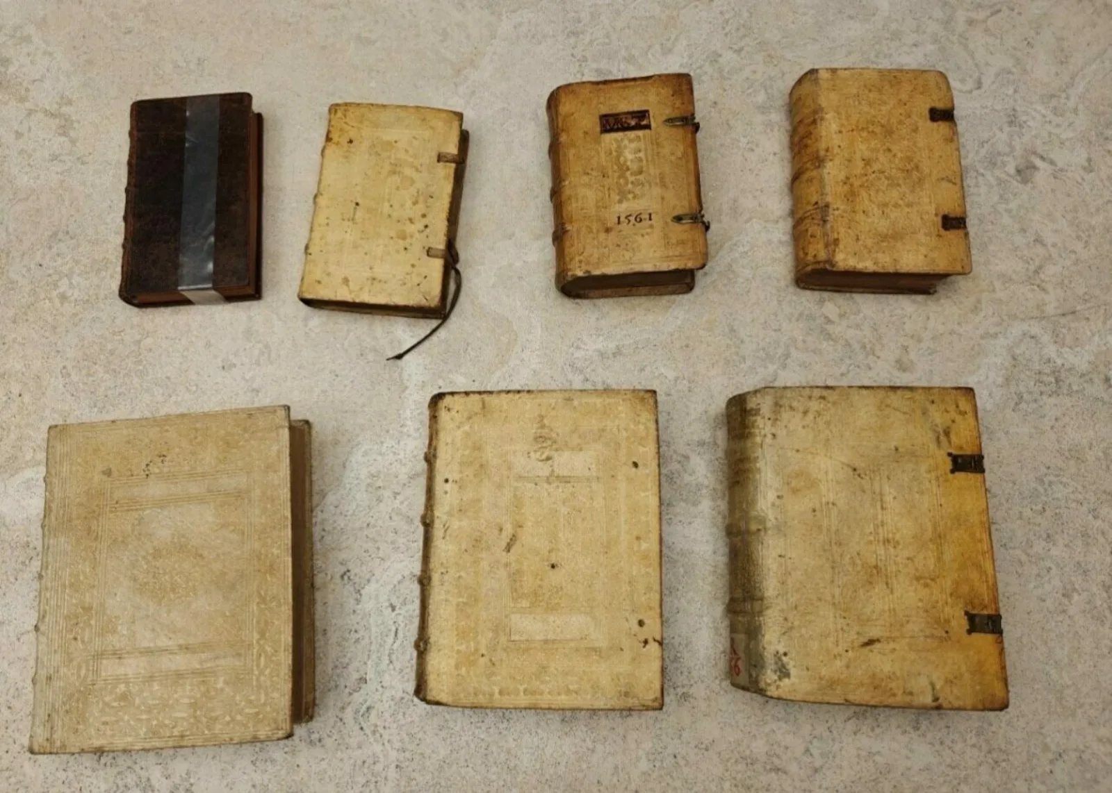Overhead View of Books Seven historic books sit on a table top.