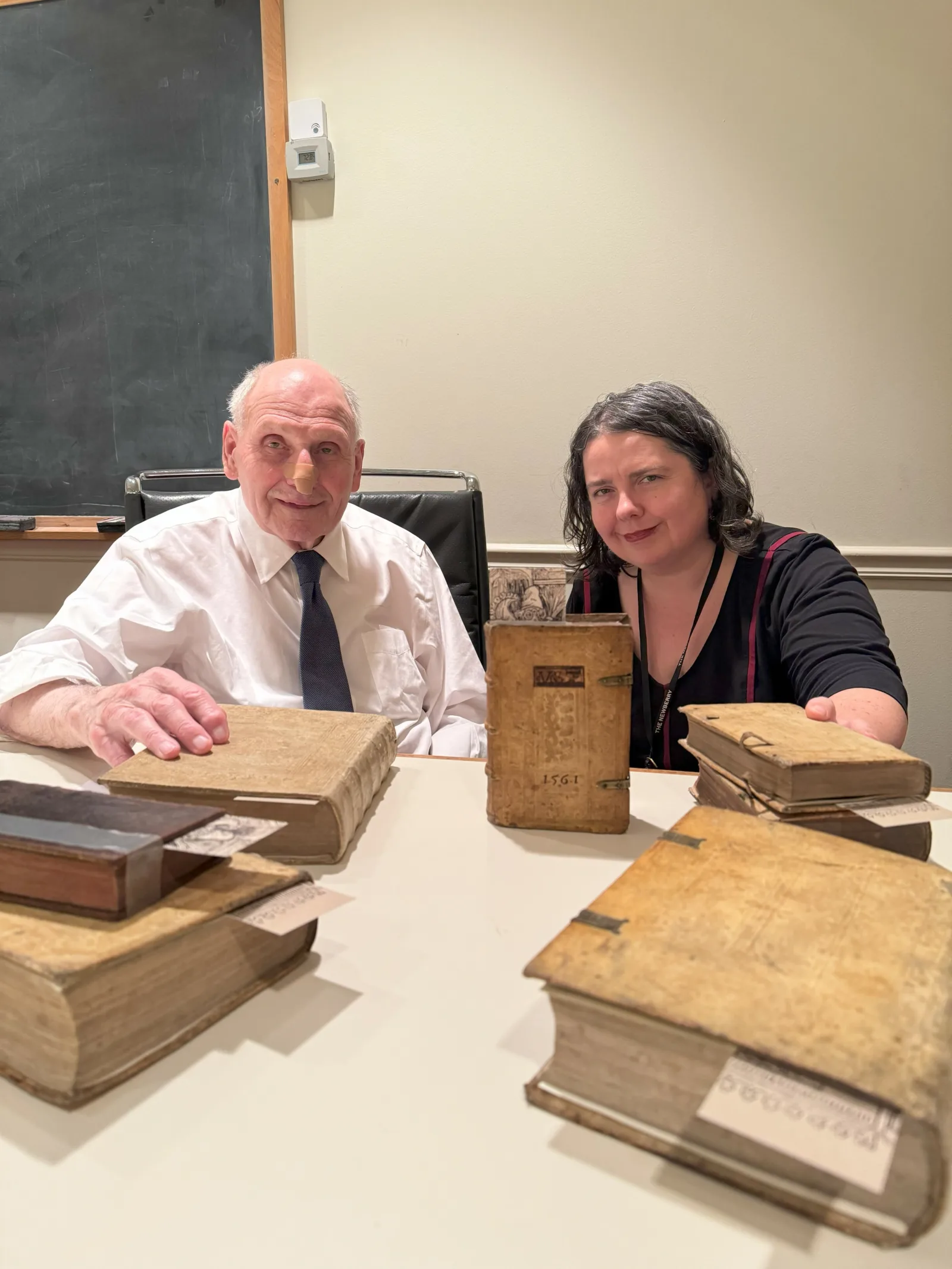 Suzanne Marvin Newberry Curator Suzanne Karr Schmidt and Marvin Rawski pose in a conference room with Rawski's lost books.
