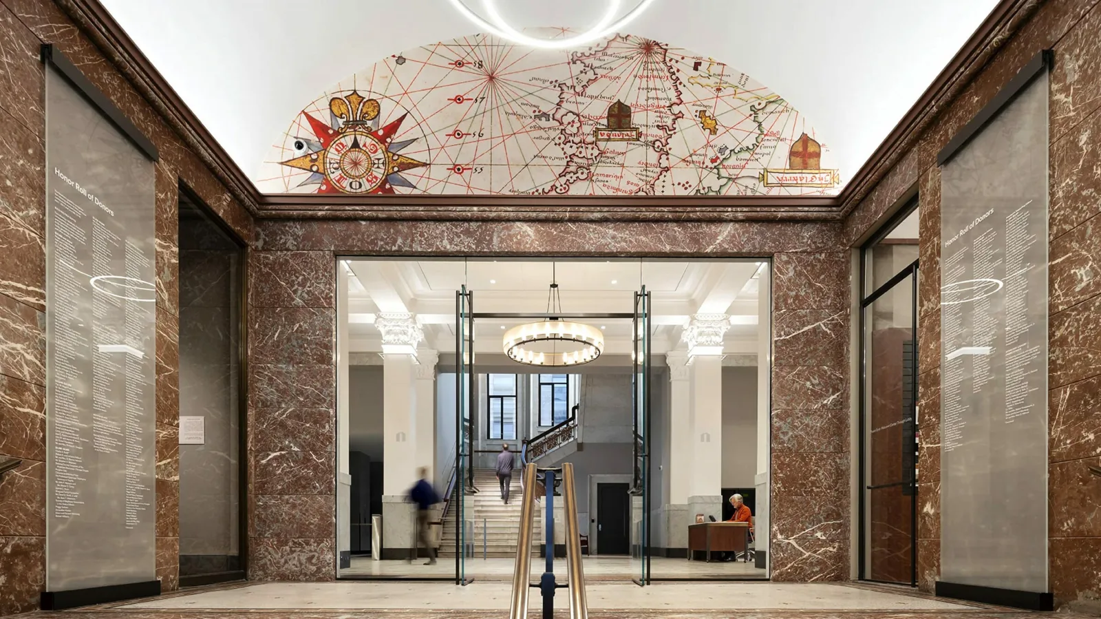 Newberry entrance Image of the interior Front Entrance Hall to the Newberry Building, a red granite walled stairway leading up to a glass doorway. The ceiling is barrel vaulted in the front hall; in the arch above the doorway is the representation a map and its compass rose.